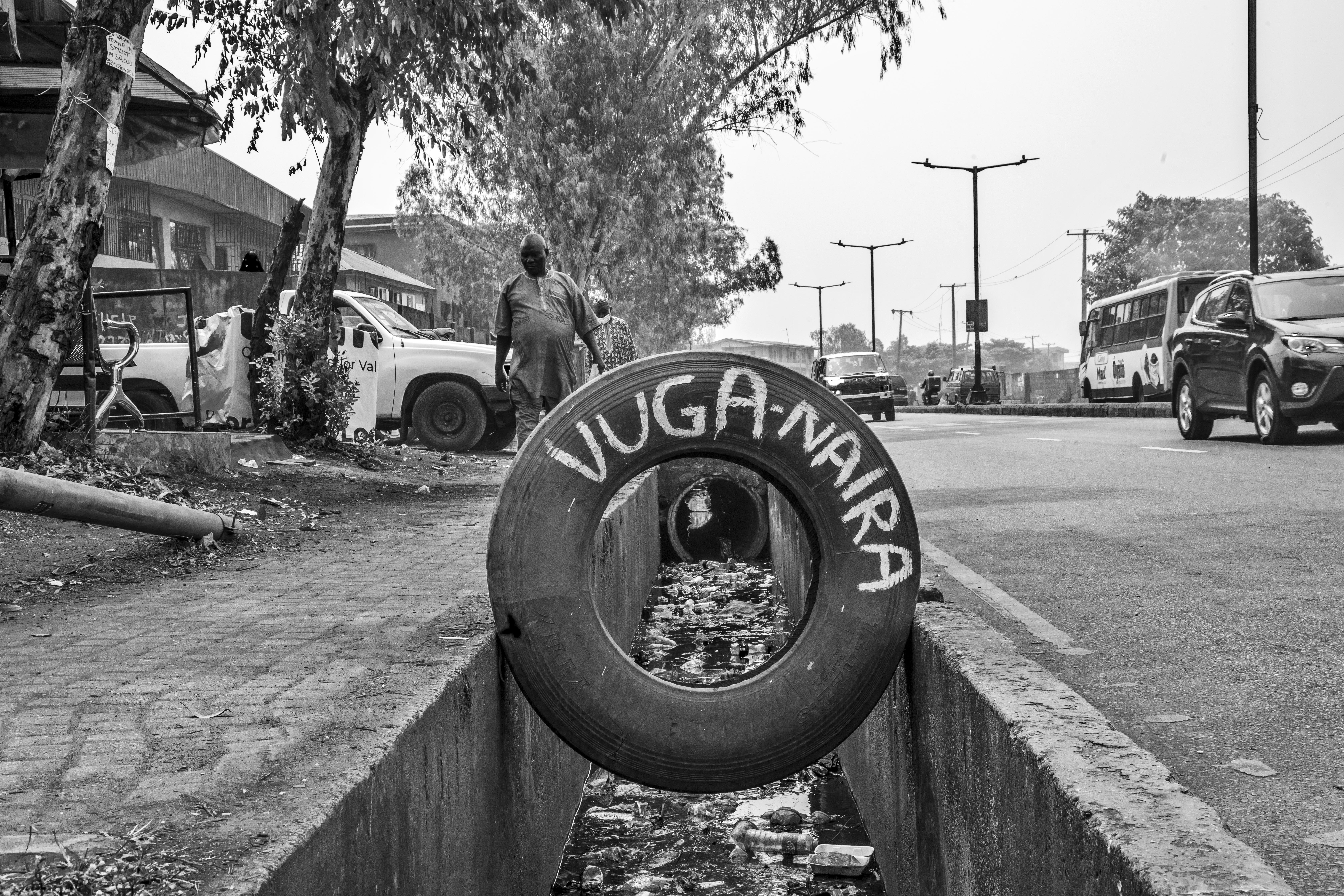 Photograph of a street centering on a tire with writing on the side