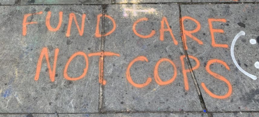 A picture of a message spray-painted onto a concrete sidewalk.