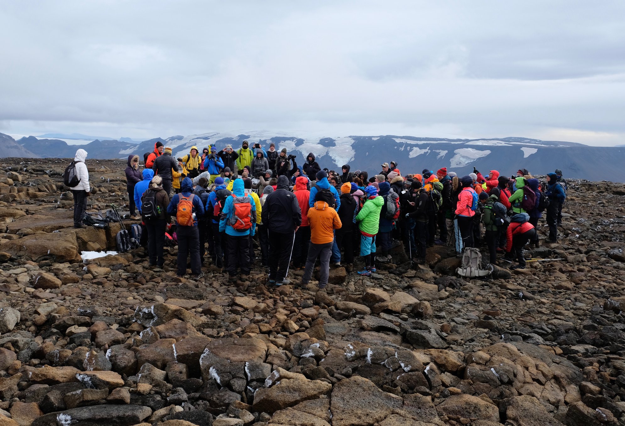 A photo of people gathered in a circle.