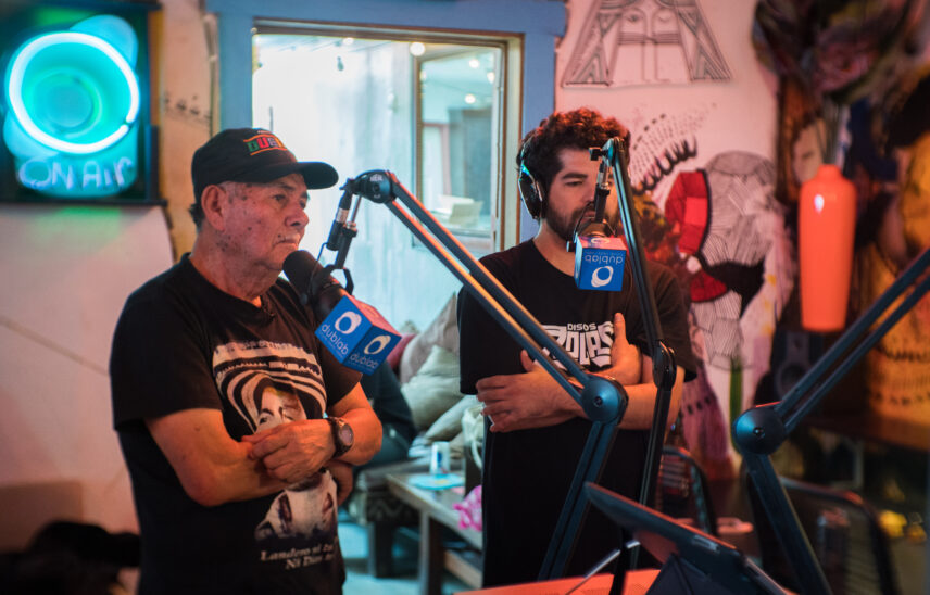 A photograph of two men in a recording studio