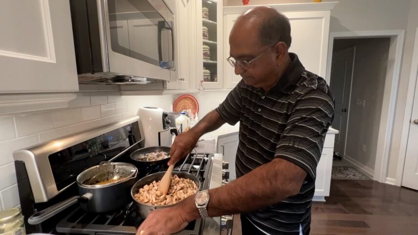 Babu preparing kalan kulumbu (mushroom curry).