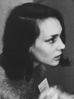 Portrait of Price as a young woman, with dark shoulder length hair and a penetrating gaze.