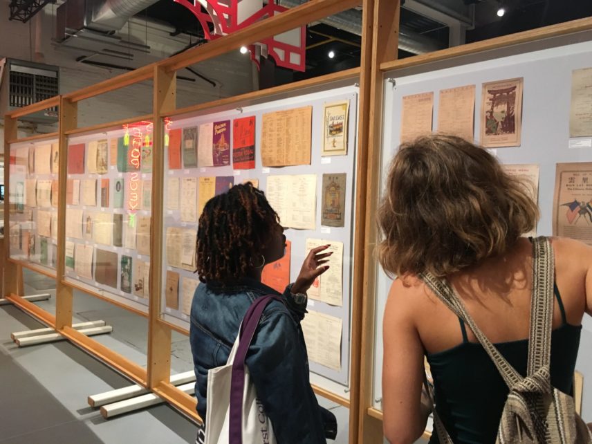Photograph of two people looking at an exhibit.