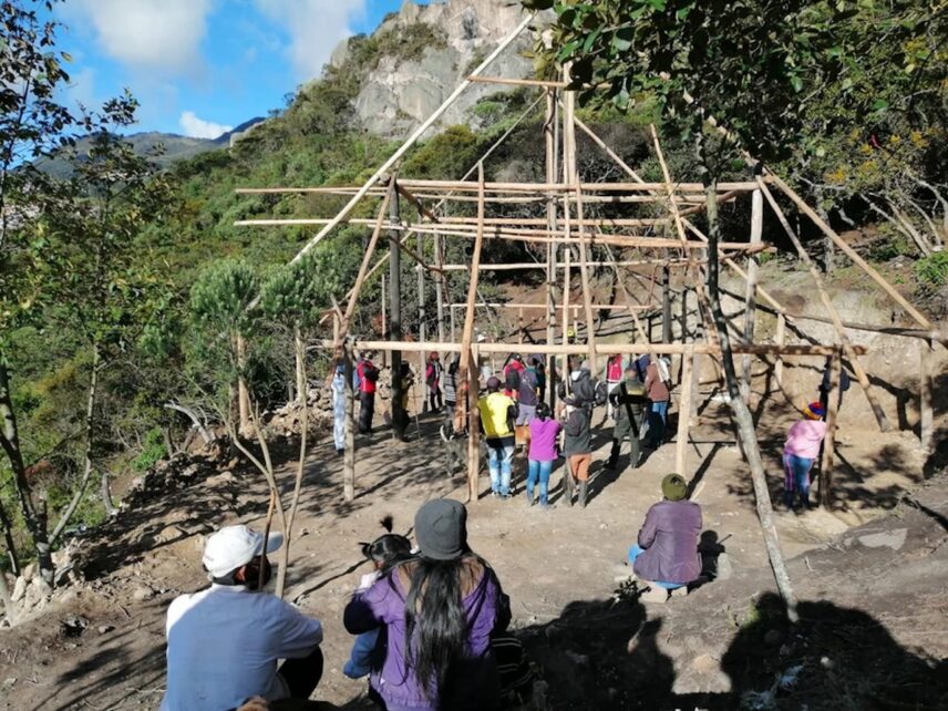 Image of Cabildo members with maloca frame.