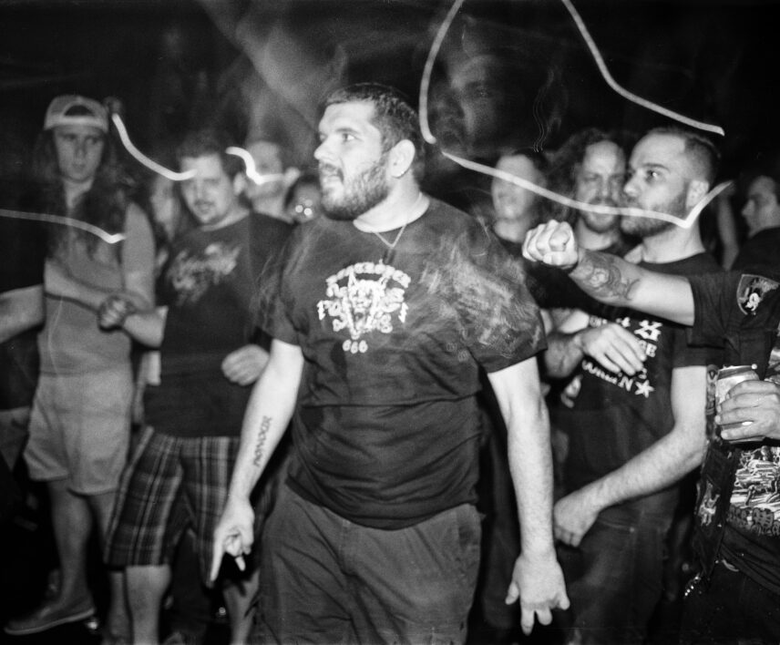 Photograph of a crowd of people, one individual centered