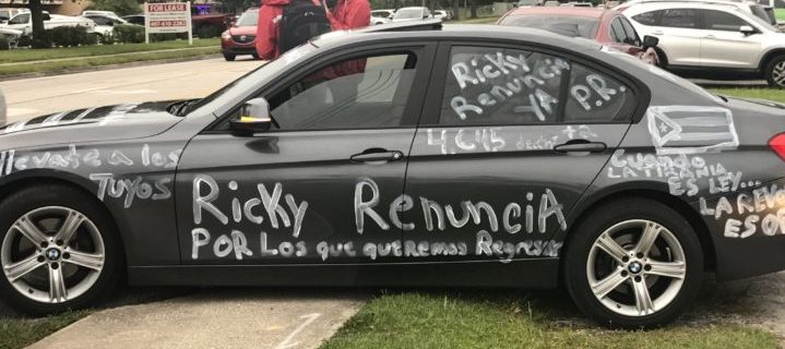 Photo of a black car with words written on it in white.