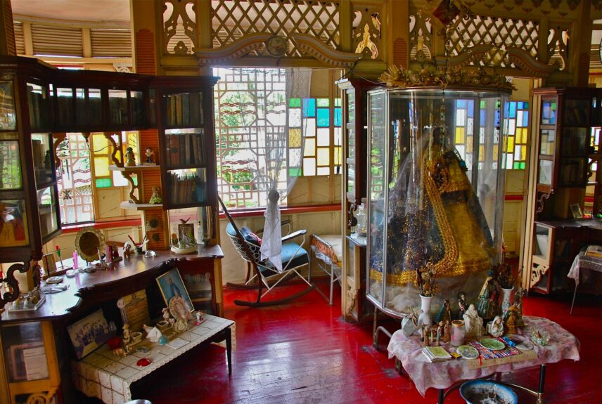 Photograph of a living room with a religious object in the center.