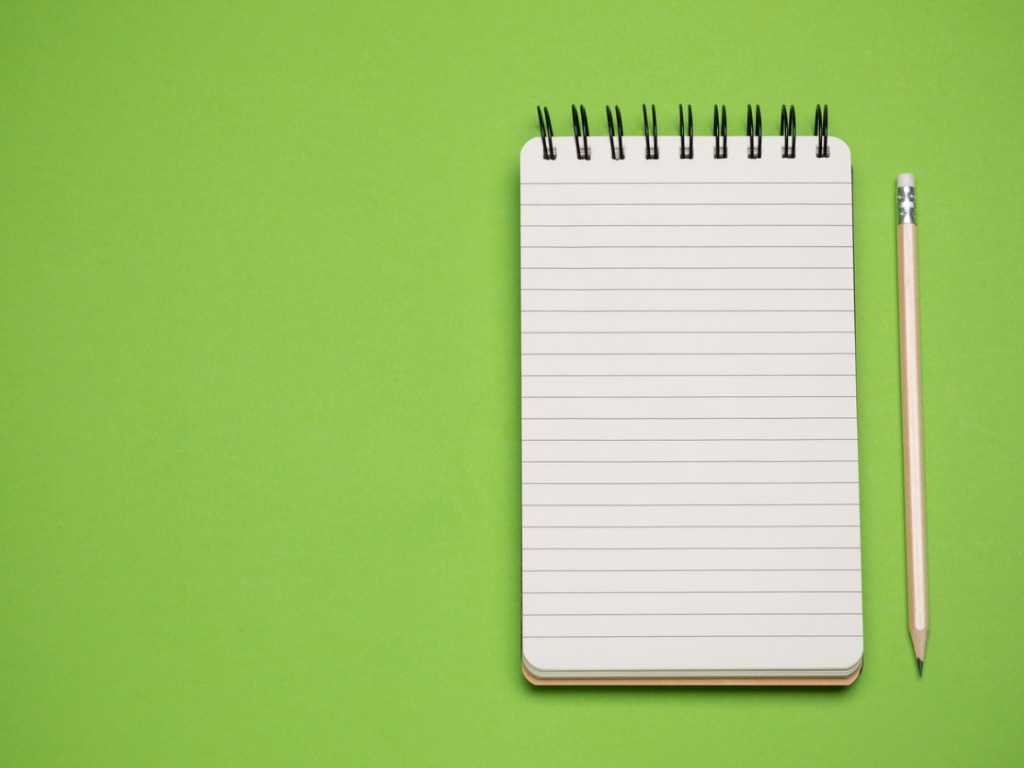 Photograph of a spiral notepad and pencil
