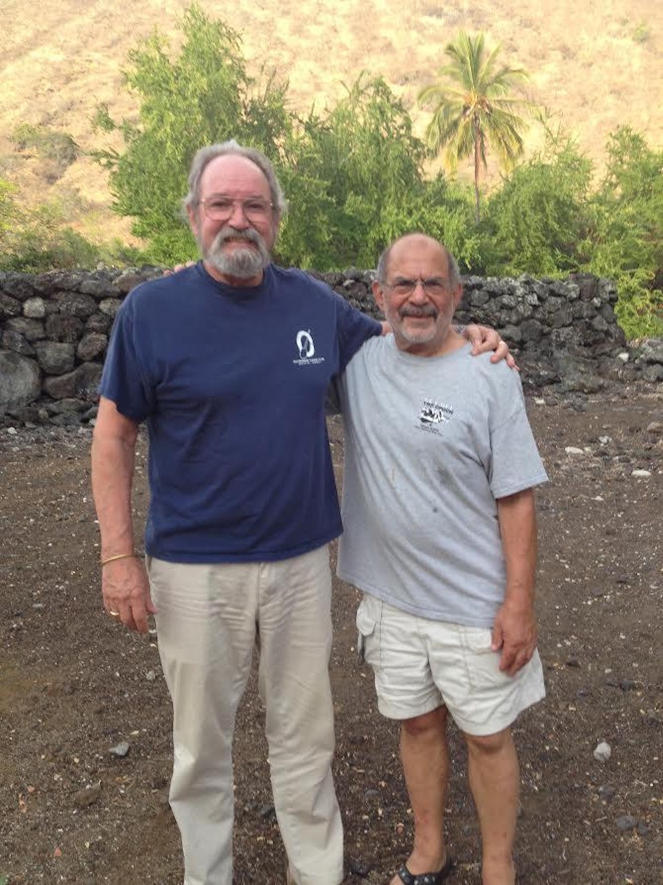 A photograph of two people standing together outside.