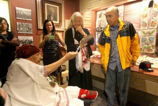 Photograph of a group of people in front of an exhibit